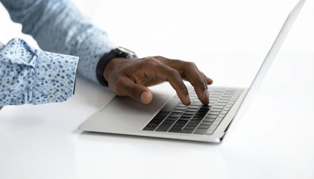 A focused professional's hands move swiftly across the laptop keyboard, deep in concentration.の素材