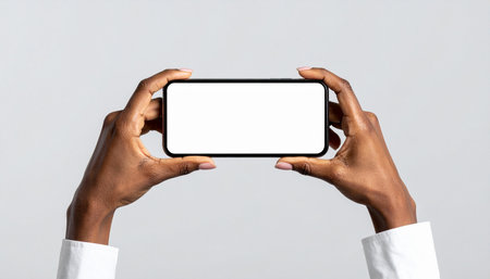 A first-person perspective of a person holding a modern smartphone, perfectly positioned for a digital mockup.の素材