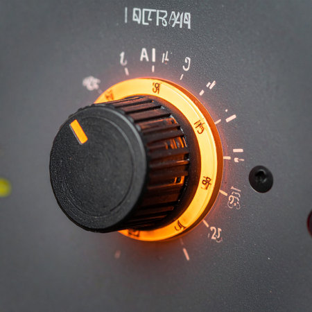 In the dim light of a recording studio, a single control knob glows with a warm orange light, representing the precise adjustment of sound.の素材