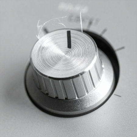 A close-up, dynamic shot of a brushed metal control knob in motion. The dial turns to adjust settings, symbolizing change, precision, and the fine-tuning of power or volume.の素材