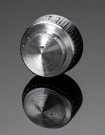 A single, precisely machined metal control knob stands as a symbol of fine-tuned adjustment and technological control.の素材
