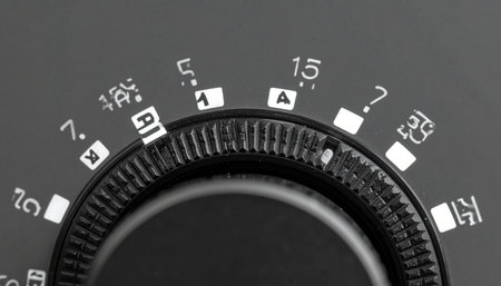 A macro, black and white view captures the intricate details of a vintage camera's shutter speed dial.の素材
