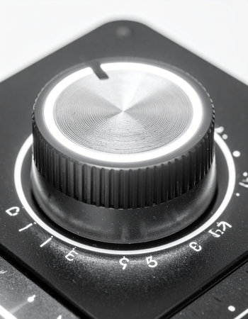 In a stark monochrome close-up, a single control knob stands ready for adjustment. Each click represents a precise change, a fine-tuning of sound, power, or signal.の素材