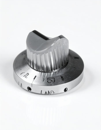 A close-up, monochrome shot of a vintage industrial control knob, isolated on a clean white background.の素材