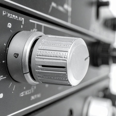 A detailed macro shot captures the textured surface of a volume knob on a classic hi-fi amplifier.の素材