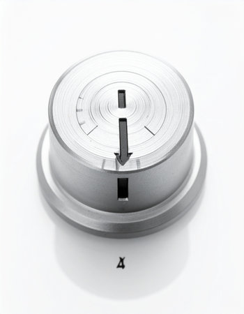 A high-key, monochrome shot of a precision-engineered metal control knob, isolated on a clean white background.の素材