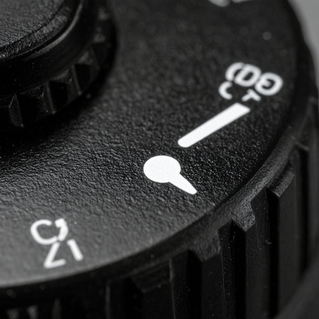 A detailed macro shot captures the precise markings on a vintage camera's focus dial, set towards infinity.の素材