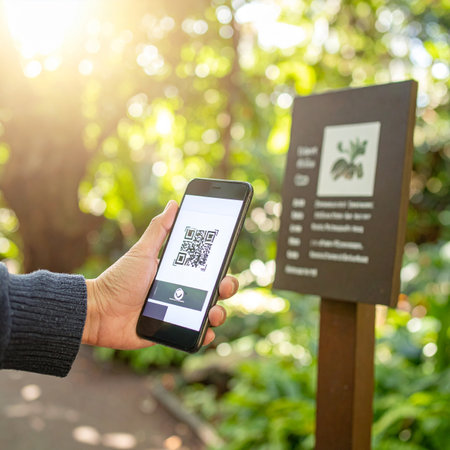 A visitor on a sun-drenched nature trail uses their smartphone to scan a QR code on an informational sign.の素材