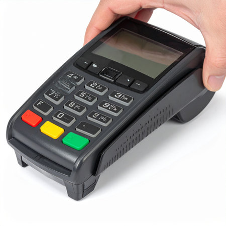 A hand presents a modern point-of-sale terminal against a clean white background, ready to complete a secure and swift transaction.の素材