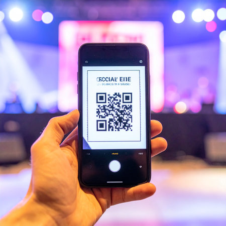 A person holds up their smartphone to display a QR code for quick and seamless entry into a vibrant tech conference.の素材