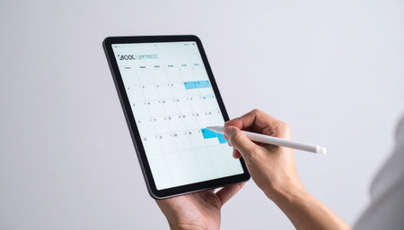 A professional uses a stylus to organize her week on a digital calendar app.の素材