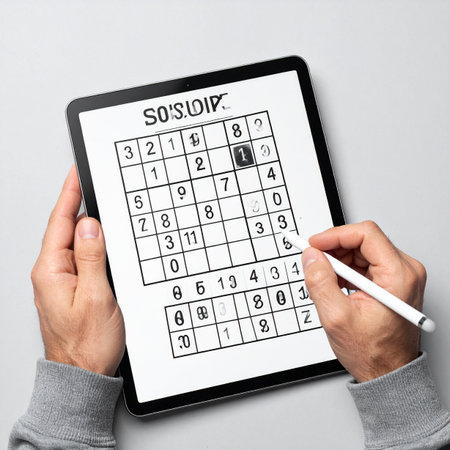 A person uses a stylus to solve a Sudoku puzzle on a modern digital tablet.の素材