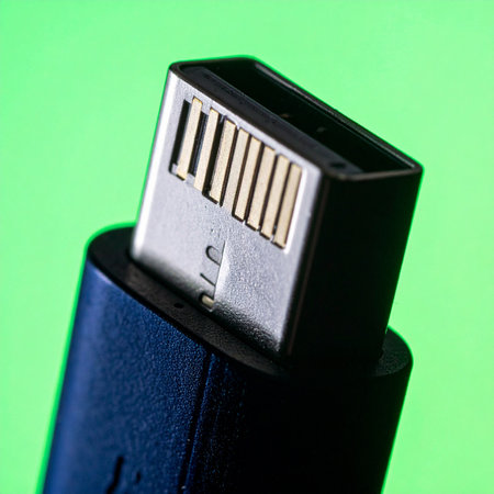 A detailed macro shot captures the intricate design of a USB-C plug, poised against a vibrant green background.の素材