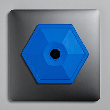 A striking blue hexagonal component is precisely centered on a sleek, dark metallic plate.の素材