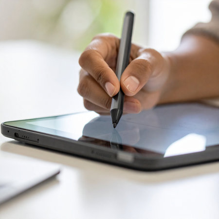A close-up shot captures the moment of creation as a graphic designer uses a stylus to bring an idea to life on a digital tablet.の素材