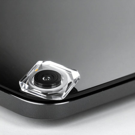 A macro view reveals the precise engineering and minimalist design of a modern digital device.の素材