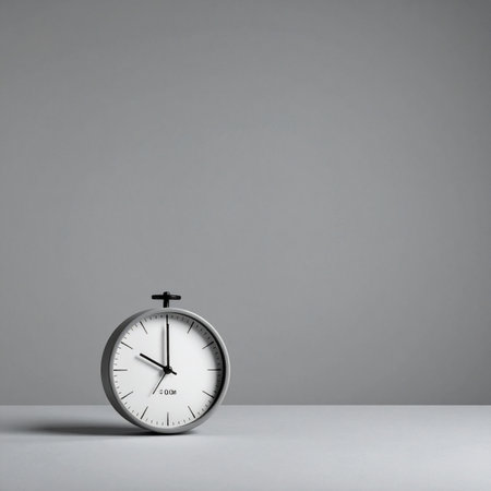 A classic analog clock sits against a clean, neutral gray background, its hands marking the steady passage of time.の素材