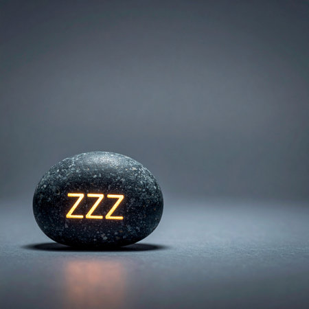A smooth, dark stone rests in a quiet space, emitting a soft, warm glow from the letters 'ZZZ'. This conceptual image represents the essential need for rest, sleep, and relaxation in a modern world.の素材