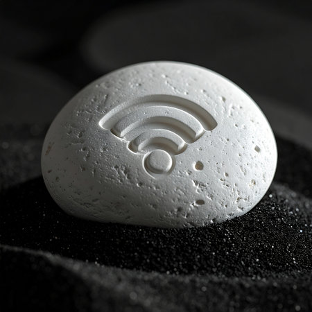 An artifact from a forgotten era or a message from the future? A Wi-Fi symbol is permanently carved into a porous stone, resting on dark sand.の素材