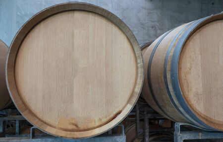 resting wooden barrels of wine in the wine cellarの写真素材