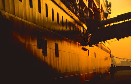 Cruise ship at sunset at hong Kong harbourの写真素材