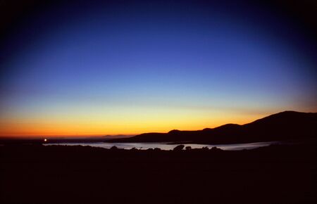 Last light at sea in the harbour of Portmaggee, Western Irelandの写真素材