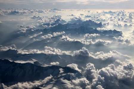 aerial over the Alps with clouds in the eveningの写真素材