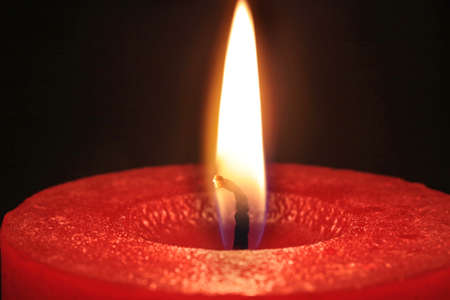 Close-up of a red christmas candle burningの写真素材