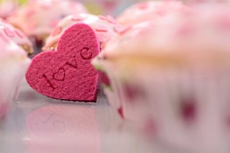 Muffins with pink icing and a shape Heart Loveの写真素材