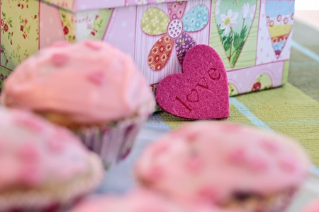 Muffins with pink icing and a heart shape Love