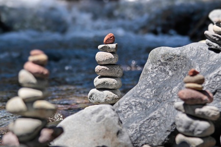 Cairn with red stone by the stream in the Tongariro National Park, Manawatu-Wanganui, New Zealandの写真素材
