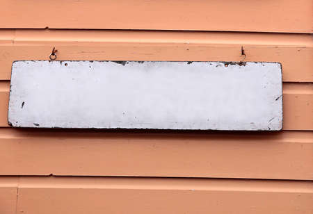 Old sign without text on brown wooden wallの写真素材