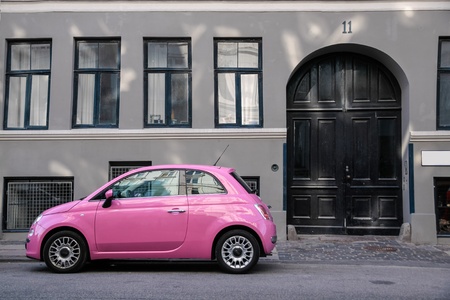 Funny pink car in front of a gray house in Copenhagen, Denmarkのeditorial素材