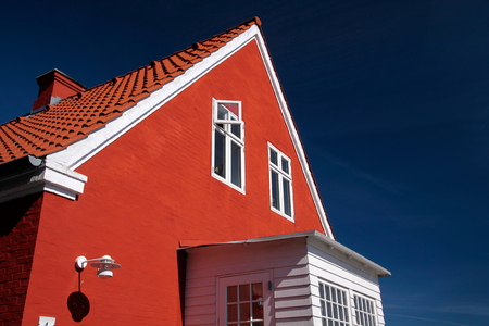 Bright red house in the small village Listed, Bornholm, Denmarkのeditorial素材