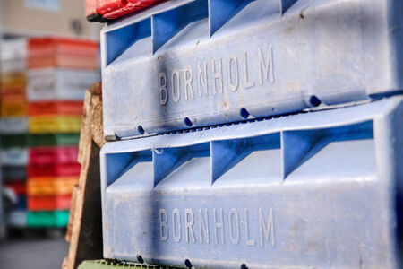 Colorful boxes for fish in the harbor of Svaneke on Bornholm, Denmarkの写真素材