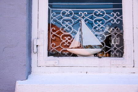 Wooden sailing ship in the window of a house in Svaneke on Bornholm, Denmark windowの写真素材