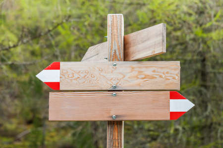 Wooden signpost (empty) in the mountains for writingの写真素材