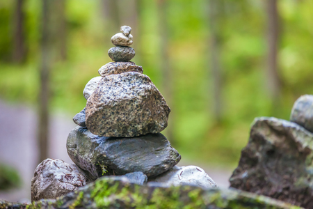 Balancing cairns in the forest in South Tyrol, Italyの写真素材
