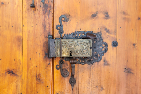 Church portal with old door lock at the parish church of St. Peter in Villnoesstal, South Tyrol, Italyの写真素材