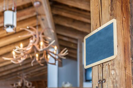 Empty chalk board hung in a mountain hut in Valle Aurina, South Tyrol, Italyの写真素材