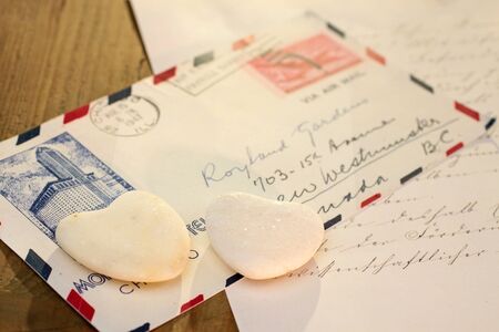 Two stone hearts with old airmail lettersの写真素材