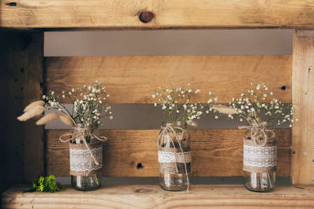 Gypsophila three jars standing on a wooden shelfの写真素材