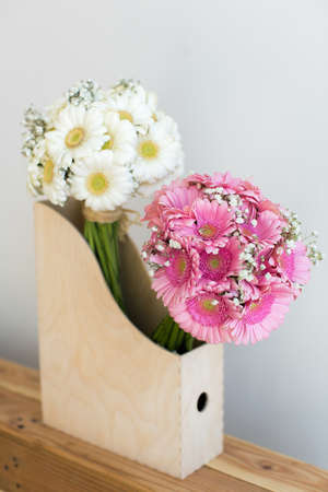 Pink and white gerbera bouquets in a wooden boxの写真素材
