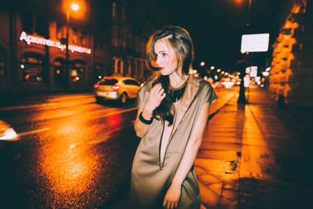 Sexy gorgeous brunette girl portrait in night city lights. Motion effect.の写真素材