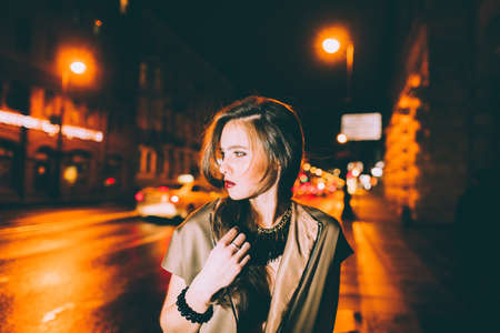 Sexy gorgeous brunette girl portrait in night city lights. Motion effect.