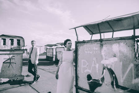 beautiful wedding couple together on the roof of a tall buildingの写真素材