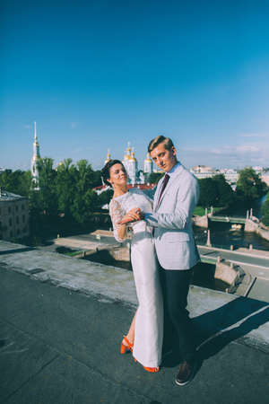 beautiful wedding couple together on the roof of a tall buildingの写真素材