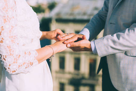 Closeup view of married couple holding hands