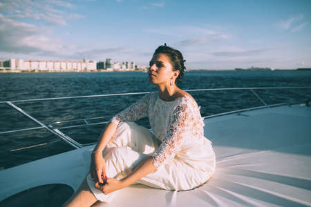 Happy bride on a yacht traveling together on a warm summer dayの写真素材