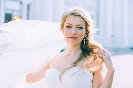 Portrait of the young beautiful bride with a veil